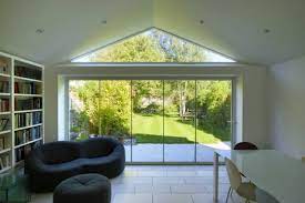Wall pockets allow the sliding windows to be fully retracted out of sight. Frameless Glass Curtains North West Bifolds