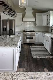 The grey and white veins in the granite add to the flow of the room. White Kitchen Great Room With Speckled Pearl Granite Home Decor Kitchen Kitchen Cabinets And Countertops Kitchen Design