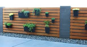 Learn how to create a wood slat wall in your home. Remodelaholic Diy Wood Slat Garden Wall With Planters