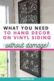 How To Hang Things On Vinyl Siding Without Damaging Your Home Vinyl Siding Decor Hanging Decor