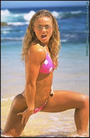 Fitness model Tina Rigdon dons shades while modelling swimwear on a beach -  Pichunter