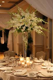 Long wedding centerpiece adorned with multiple flower vases that are complemented by their small. Pin On Wedding Ideas