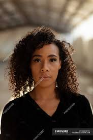 Choose the trendiest medium length hairstyles for men to emphasize those locks of yours as you can go for anything from a quiff to shaggy hair & more! Portrait Close Up Of A Young Mixed Race Female Ballet Dancer With Shoulder Length Curly Hair Looking Straight To Camera In An Empty Warehouse Loneliness Fit Stock Photo 308892194