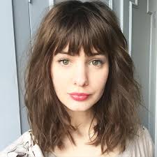 Shoulder length, silky and soft blonde hair styled with sweeping, long bangs and worn in a side parted fashion for a casual look. Digging The Bangs Medium Length Curly Hair Curly Hair With Bangs Medium Hair Styles