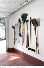 If your garage is spacious enough and you aren't comfortable hanging your garden tools, you can buy some shelving units to store them there instead. Storage Ideas Garage Iinside Of Garage Door New Construction Vertical View Of Garden Implem Garage Organization Garage Organization Diy Garage Wall Storage