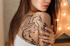 A Young Woman Hugging Herself And Showing Off A Tattoo Covering The Shoulder And Back Easily Upload Your Own Design And Make Tattoos Back Tattoo Cover Tattoo