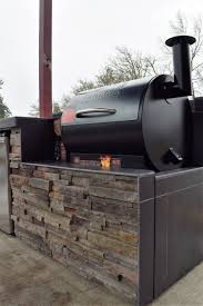 Adding an outdoor barbeque kitchen to your living space is essential for entertaining. Outdoor Kitchen Pellet Grilling With A Traeger Custom Outdoor Kitchens And Fire Features Sunset Outdoo Outdoor Kitchen Outdoor Kitchen Design Backyard Kitchen