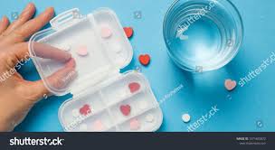Heart Pills Pills In A Pill Box With A Glass Of Water On A Blue Background The Patient Organizes The Medication The Concept Of Health Pill Water Pills Pills