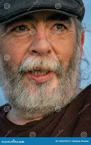 Portrait of Caucasian Man Smiling with White Beard and Cap Stock Photo