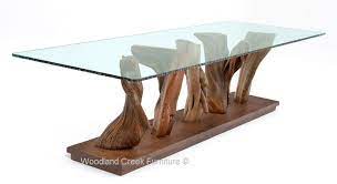 Natural Wood Is Used In A Modern Organic Modern Dining Table Design Featuring A Thick Glass Top Fo Modern Dining Table Organic Modern Dining Table Dining Table