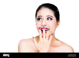laughing beautiful girl using hand with art nails cover the opened mouth  and colorful eyes watching copyspace