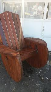A staple gun and upholstery needle secure the cushion to the wood frame. Wire Spool Adirondack Rocking Chair Upcycle Upcycle Chair Cable Spool Furniture Adirondack Rocking Chair