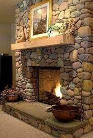 The beige stones really add great texture to the room. 50 Beautiful Fireplace Decorating Ideas To Copy For Your Own Godiygo Com Stone Fireplace Designs River Rock Fireplaces Fireplace Design