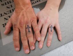 A tiny small ans simple cross tattoo design on middle finger. 49 Creative Cross Tattoos On Fingers