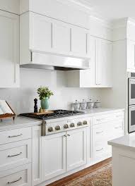 White Wood Hood Metal Band Modern White Kitchen With Breakfast Table Built In Banquette White S White Modern Kitchen Kitchen Soffit White Kitchen Appliances