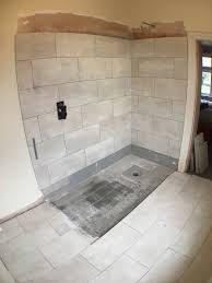 Be sure to line up the tile with your penciled layout to get the placement right on the first try. Process For Tiling A Wet Room Tray With Large Tiles Uk Bathroom Guru