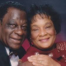 Bishop William Matthew Roberts and Mother Mamie Roberts surrounded by  flowers. Bishop Roberts was the founder of the Historic Roberts Temple  COGIC in Chicago, Illinois in 1916, Founding Bishop of the Historic