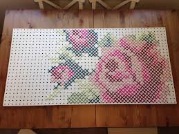 Yarn in 4 colors for the petals. My Giant Yarn Cross Stitch Rose On Peg Board Cross Stitch Embroidery Cross Stitch Rose Cross Stitch Flowers