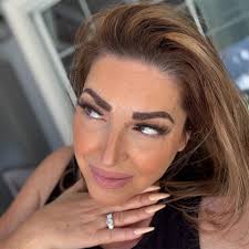 What could be causing a slight squeaking sound in a Tesla when driving  under 10 mph from the driver side rear wheel and