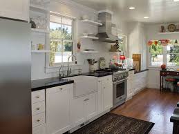 One wall kitchen designs basically use only one side of kitchen wall space to place kitchen appliances, storage, cabinetry and countertops to create functional kitchen layout for workspace. One Wall Kitchen With White Shaker Cabinets Farmhouse Sink Hardwood Floors And Arabi Kitchen Designs Layout One Wall Kitchen Farmhouse Style Kitchen Cabinets