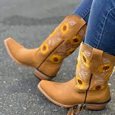 Perky gold sunflowers peek out of the top of these cowboy boots on this unique clock. Sunflower Cowgirl Boot El Potrero Western Wear