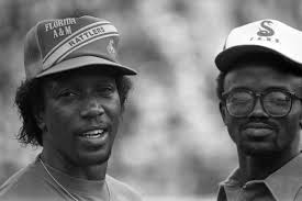Portrait of Rev. Ernest Ferrell (right) with brother and restaurateur, Elbert  Ferrell Sr. standing in front of Ferrell's Restaurant