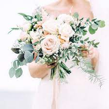 Want to try something less expected than usual white and ivory colors in your wedding theme? A Beautiful Blush And Cream Rose Wedding Bouquet With Textural Greenery For A Neutral Colored Wedding Bouquets Pink Rose Wedding Bouquet White Wedding Bouquets
