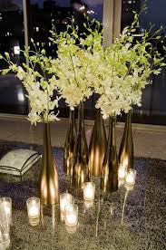 Create your own ice sculpture with the champagne bucket ice mold centerpiece worthy and a conversation starter, this wine bottle holder sports a super cute and. Wedding Decorative Bottles Gold Sprayed New Years Wine Bottle With Orchids As Centerpiece For 2015 New Ye Decor Object Your Daily Dose Of Best Home Decorating Ideas Interior Design Inspiration