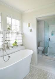 The reason is water vapor coming from the shower and bathtub area and condensation. White And Gray Cafe Curtains Over Bathtub Transitional Bathroom