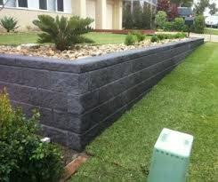 Retaining Walls Are A Great Way To Elevate Garden Beds Creating A Split Level Effec Backyard Retaining Walls Garden Retaining Wall Landscaping Retaining Walls