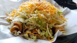 400g of cod, 1 lime, juiced, 1 red chilli, chopped, 50ml of olive oil, 4 tomatoes, ripe, 1 red onion, 1 lime, 20g of coriander, 1 avocado, salt, 1/4 red cabbage, taco shells. Taquito Wikipedia