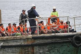 Happy young couple in red santa hats sitting on beach chairs. Asylum Seekers Arrive At Christmas Island Tuesday 15th May 2012 Devpolicy Blog From The Development Policy Centre