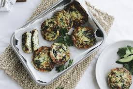 A green ceramic dish with spinach and red pepper dip on a green plate with crackers. Spinach Recipes Australia S Best Recipes