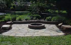 An outdoor fireplace or fire pit can add aesthetic and entertainment value to any space. Flagstone Patio With Fire Pit Progressive Lawnscaping Outdoor Fire Pit Outdoor Fire Pit Designs Fire Pit Backyard