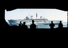 Crew members of USS George Washington watch the HMS Invincible come  alongside.