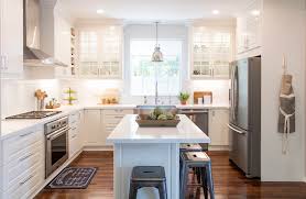 We love how this kitchen features big glass framed cabinets and a lovely farmhouse sink. White Ikea Modern Farmhouse Style Kitchen
