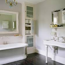 Light wood cabinetry on the vanity adds a. An English Bathroom With Dark Floors And Light Gray Walls Buckboard Hill Interiors