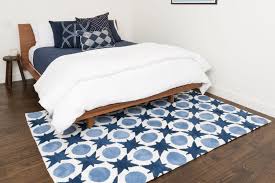 A 6′ x 9′ or 8′ x 10′ area rug works under a queen bed up against the wall. What Size Rug Goes Under A Queen Bed Plushrugs