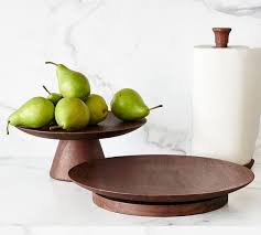 The sisters' paper towel holder is made of acacia wood and measures 30.4 cm in height. Chateau Handcrafted Wood Paper Towel Holder Pottery Barn