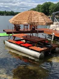 What A Fun Project Started Out With A Old Paddle Boat Repurposed The Pontoons Into This Fun Floating Table Lakefront Living Floating Picnic Table Boat Decor