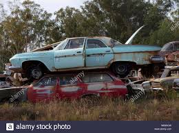Rusty old cars from the 1950s and 1960s abandoned in a wrecking yard car  graveyard in rural Australia Stock Photo - Alamy