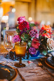 Choose flowers in bold jewel tones, fabric for table runners and chair décor. 25 Jewel Toned Wedding Centerpieces Sure To Wow Your Guests Martha Stewart