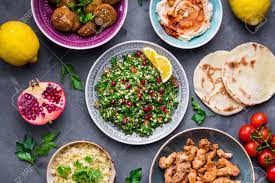 Some with meat, some with barley, rice, tomato or pomegranate molasses. Assorted Middle Eastern Dishes And Meze Tabbouleh Salad Meat Shawarma Hummus Bowl Falafel Pita Bulgur Pomegranate Lemons Arab Cuisine Party Food Middle Eastern Dinner Ethnic Food Top View Stock Photo Picture And