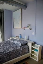 It has a wooden frame with a gently arched top and covered legs. 53 Insanely Clever Bedroom Storage Hacks And Solutions