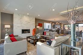 Open floor plans have been the dominant architectural trend in new residential construction since about 1990. Large Luxury Home Interior With Open Floor Plan Features Modern Kitchen Spacious Dining Area And Gray And White Living Room With Gorgeous Fireplace Stock Photo Picture And Royalty Free Image Image 97874032