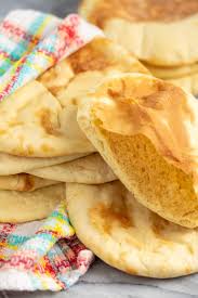 Put 2 pitta rounds at a time on the hot pizza stone and bake for 3 to 4 minutes, or until the bread puffs up like a balloon and is pale golden. Homemade Pita Bread
