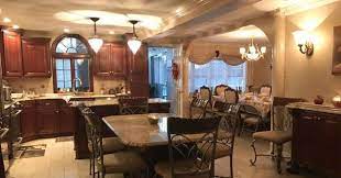 Three decorative pendant lights over the large island add interest to this elegant kitchen. Bathroom Kitchen And Basement Remodeling Staten Island Ny