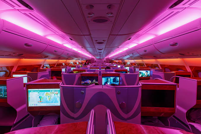 Nick - The Business Class cabin onboard the upper deck of an Emirates  Airbus A380 with mood lighting in full effect. The seat hasn't changed  since they debuted the aircraft in 2008