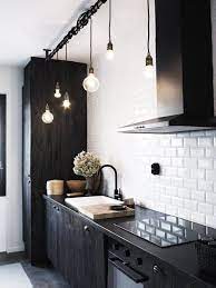 Black is masterful here, offset by a timber tones and the enormous expanse of glass in the surrounding windows, with a clear view to the pool beyond. Tired Of Granite 8 Countertop Alternatives To Consider Black Kitchen Faucets Kitchen Design Small Kitchen Interior