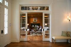 Double pocket doors with transom separates the dining room from a stylish home office. Double Pocket Doors Or Hinged Doors